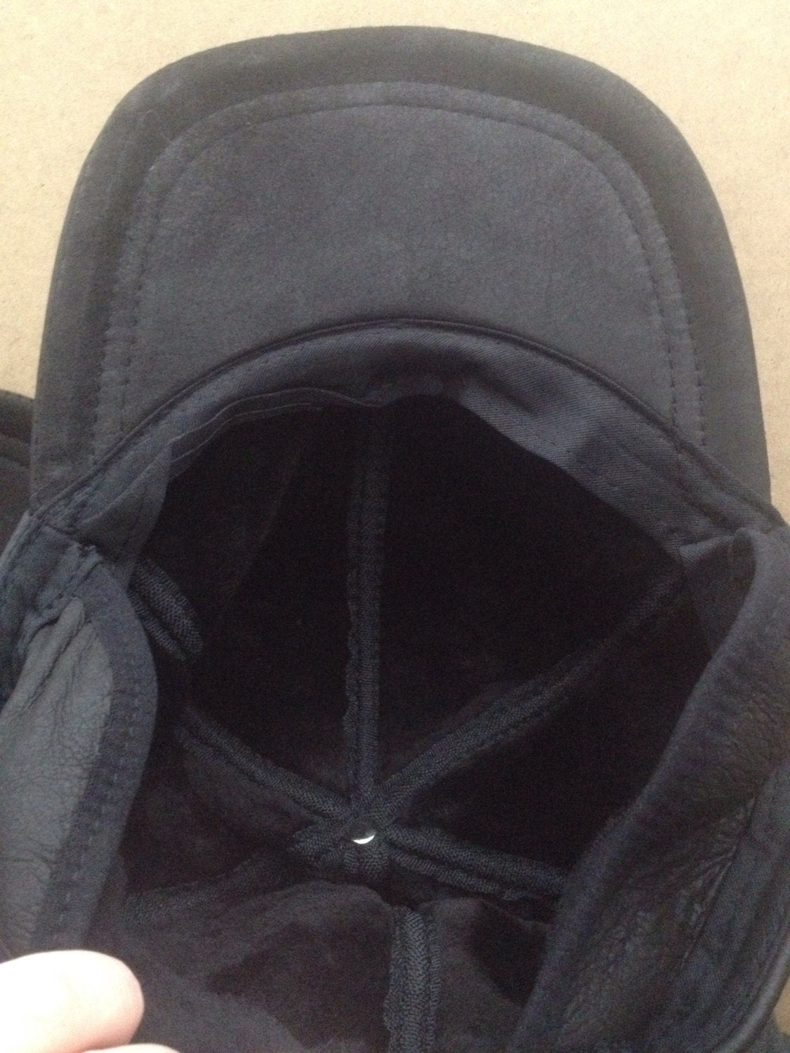 Real shearling - leather cap with ears and fur inside.