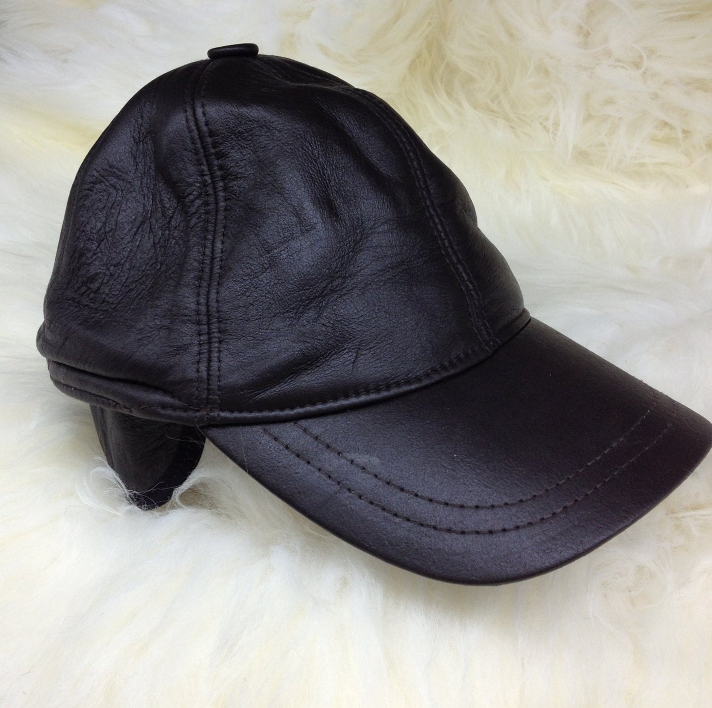 Real shearling - leather cap with ears and fur inside.