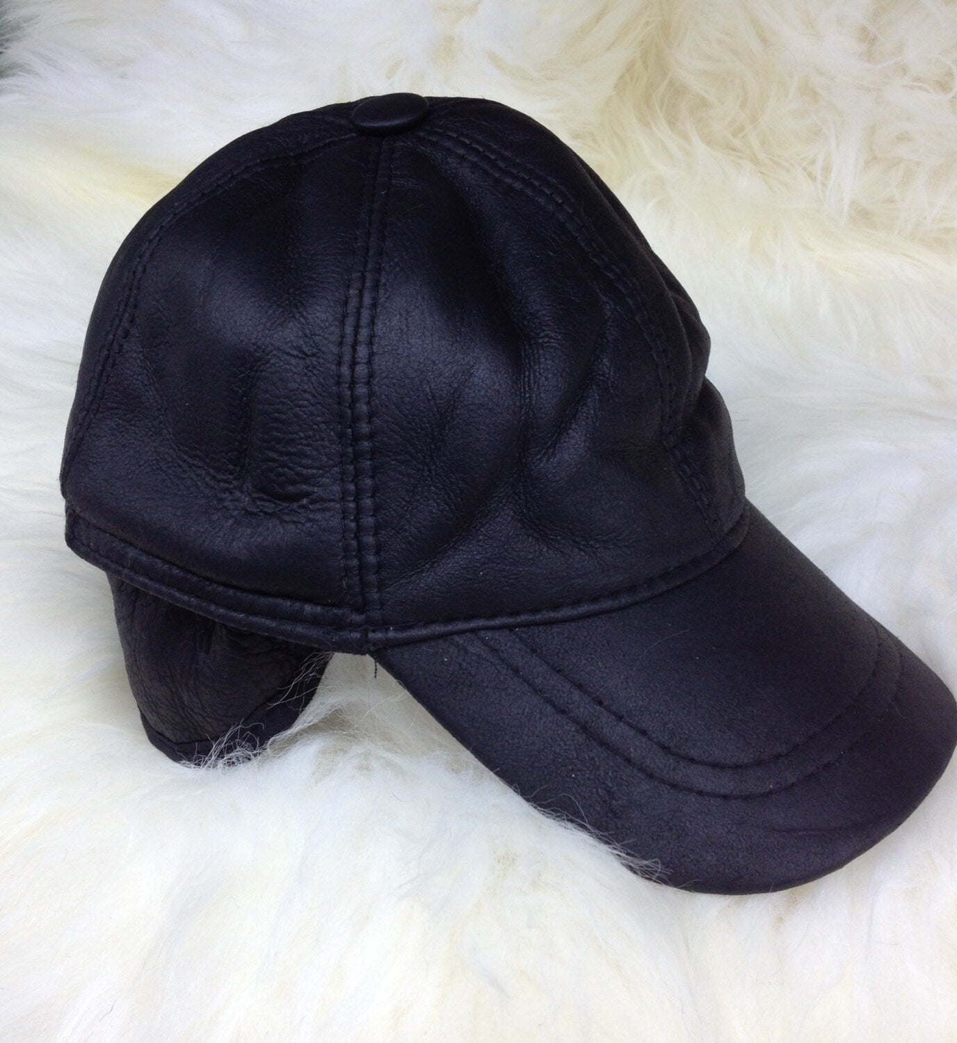Real shearling - leather cap with ears and fur inside.
